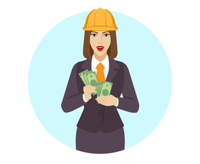 Obraz premium Businesswoman in construction helmet counting money