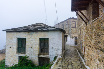 Fototapeta na wymiar Winter foggy scenery in Kastanitsa village in Arcadia Greece. It is a traditional settlement and It is noted for its production of chestnuts