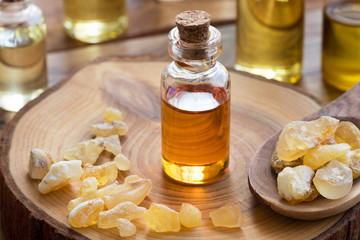 Obraz na płótnie Canvas A bottle of frankincense essential oil with frankincense resin