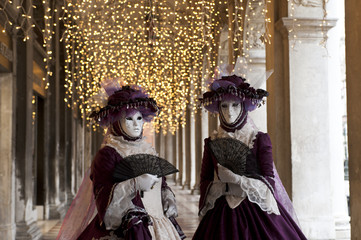 Couple of carnival masks in St. Mark's Square in Venice. Italy