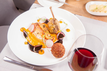 Guinea fowl, pumpkin puree, fried buckwheat, gravy sauce served in a restaurant