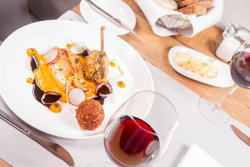 Guinea fowl, pumpkin puree, fried buckwheat, gravy sauce served in a restaurant