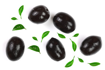 whole and sliced black olives decorated with leaves isolated on white background. Top view. Flat lay pattern