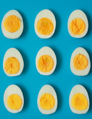 Boiled eggs cut in half on colorful background. 

