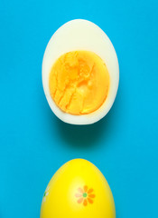 Boiled eggs cut in half on colorful background. 

