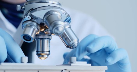 Scientist hands with microscope close-up shot in the laboratory - Powered by Adobe