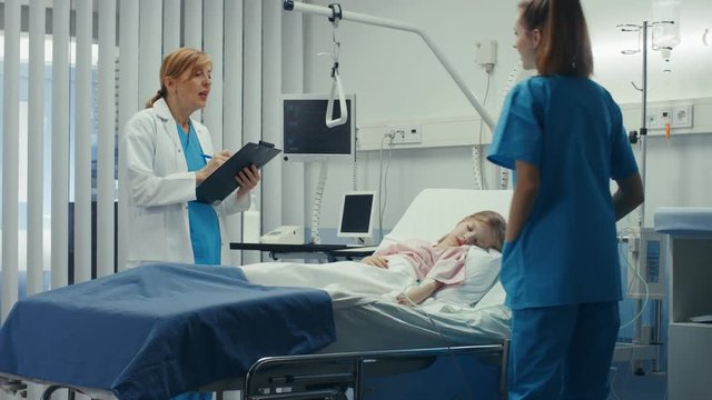 Sick Little Girl Lies on a Bed In the Hospital, Friendly Doctor Writes Medical Record/ Data into Clipboard, Talks with Nurse. Shot on RED EPIC-W 8K Helium Cinema Camera.