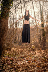 Almost Levitation... Woman standing on a very thin tree's branch