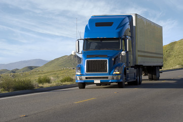 Blue modern semi truck reefer trailer carry cargo on highway