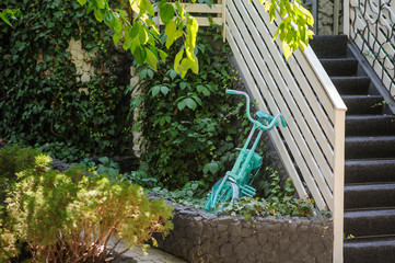 Blue old vintage bicycle/bike forgotten in leaves wall outdoor