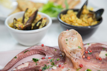 Fried fish,rice with mussels and octopus on dish with lemon and salad. Typical sicilian food