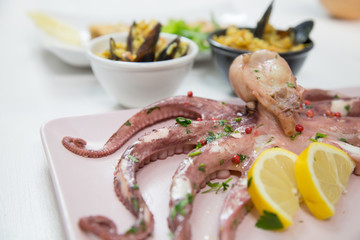 Fried fish,rice with mussels and octopus on dish with lemon and salad. Typical sicilian food