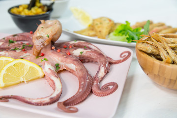 Fried fish,rice with mussels and octopus on dish with lemon and salad. Typical sicilian food