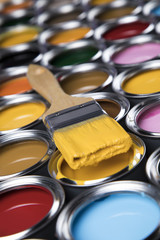 Colorful paint cans with paintbrush