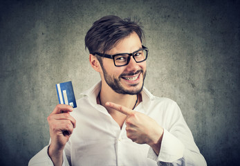 Excited man with credit card enjoying bank borrow