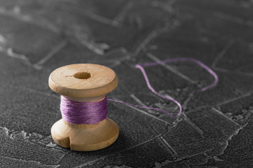 Fototapeta na wymiar sewing thread on an old wooden spool