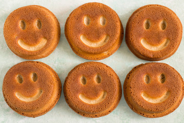 Funny homemade cupcakes in form of smiling face