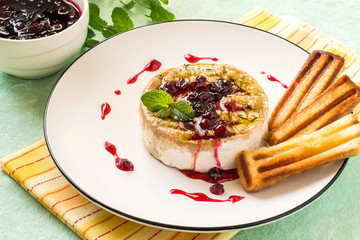 Baked brie cheese with cowberry sauce