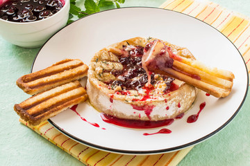 Baked brie cheese with cowberry sauce