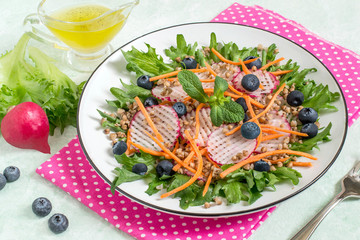 Vitamin vegetarian salad with buckwheat, vegetables and blueberries