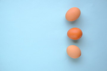 Eggs on blue background top view