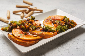 sliced baked pumpkin, with broccoli and assorted vegetables