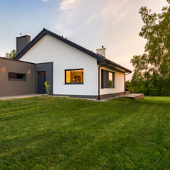 Fototapeta na wymiar Stylish house with large lawn