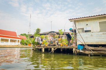 Fototapeta na wymiar Outdoor view of floating poor house on the Chao Phraya river. Thailand, Bangkok