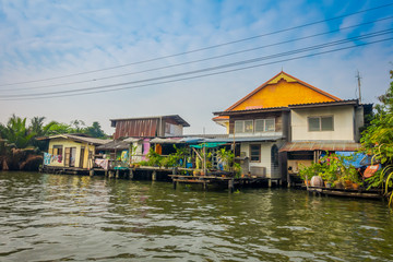 Fototapeta na wymiar Outdoor view of floating wooden poor house located on the Chao Phraya river. Thailand, Bangkok