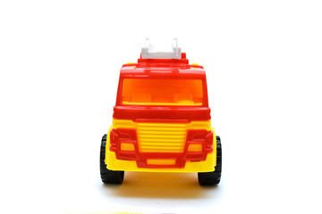 Children's toy fire truck isolated on white background - front view.