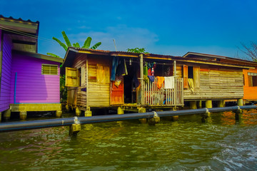 Fototapeta na wymiar Outdoor view of gorgeous floating wooden house with a pipeline on the Chao Phraya river. Thailand, Bangkok