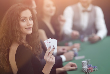 beautiful woman showing a combination of four aces.