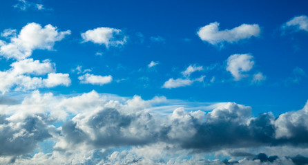 Naklejka na ściany i meble Blue cumulus clouds in the clear summer sky.