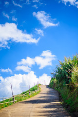 Beautiful Mountain rural Concrete Road in blue sky and white clouds