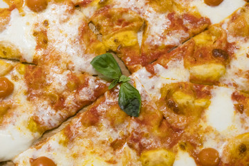 Food. Pizza with tomato, salami and olives. Pizza with ham, pepper and olives. Delicious fresh pizza served on wooden table.