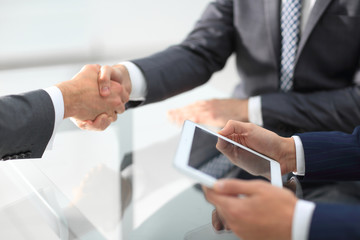 Two confident businessmen shaking hands during a meeting in the