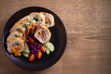 Chicken Cordon Bleu. Chicken breast wraps with ham and cheese, overhead, top view, room for text
