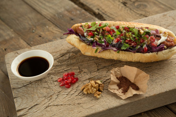 French bun sandwich with sausage and onion.