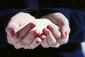 Rice in female hands closeup