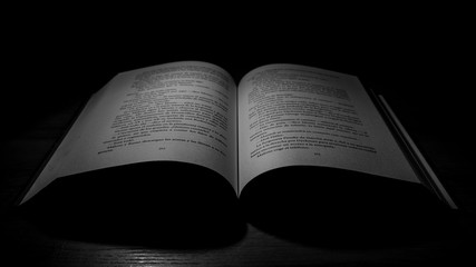 Fototapeta premium black and white image of a book in the dark