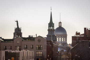 Fototapeta na wymiar Marche Bonsecours in Montreal, Quebec, Canada, into the light during a winter morning, surrounded by other historical buildings. Bonsecours Market is one of the main attractions of Old Montreal