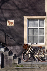 a bicycle parked by a brownstone building