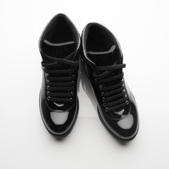 black varnished patent leather shoes isolated on white