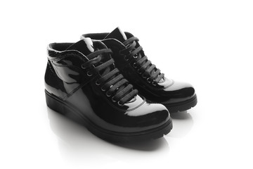 black varnished patent leather shoes isolated on white
