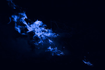 Blue flame. Fire. Burning of rice straw at night.