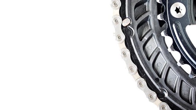 The drive gear of bicycle rotated on a white background, close-up view.