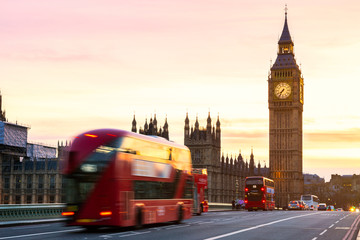 Naklejka na ściany i meble London, the UK. Red bus in motion and Big Ben, the Palace of Westminster. The icons of England