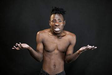 Fototapeta na wymiar emotions black young man on a black background