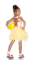 Little girl is playing with a ball