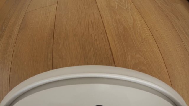 Robot vacuum cleaner on floor, Smart robotic automate wireless cleaning technology machine. Camera mounted directly on the Sweeper.